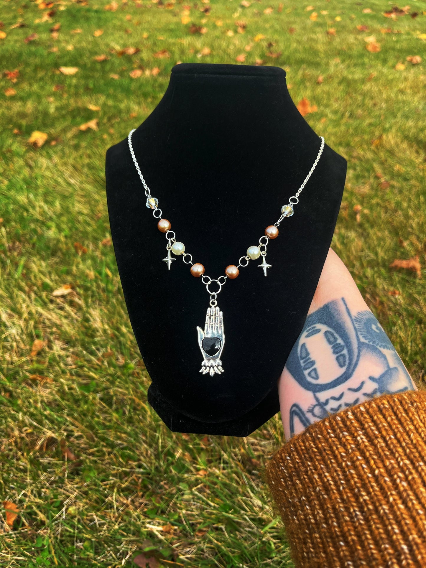 Black heart hand necklace
